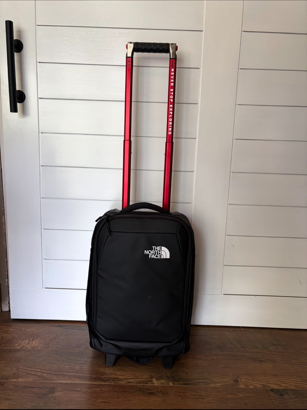 The North Face Black Rolling Carry-On with Red Handle